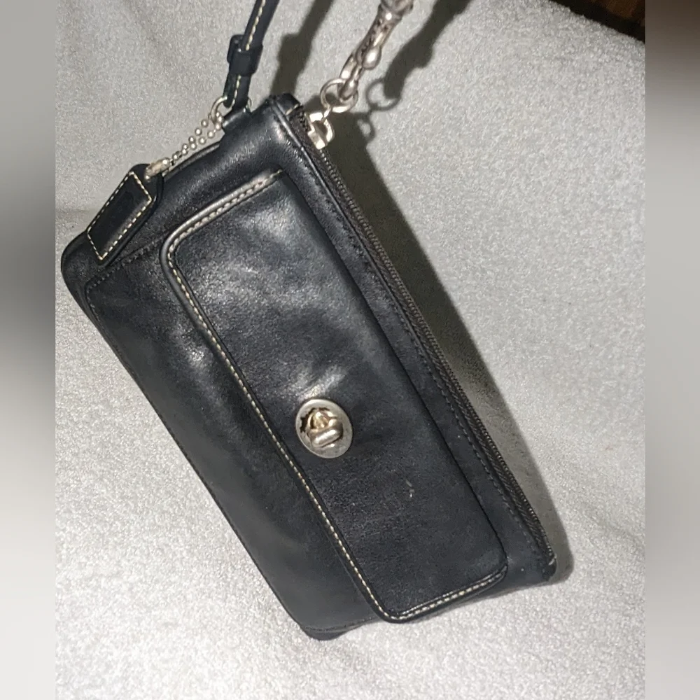 Coach black leather turn lock flap wristlet.